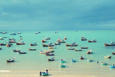 Boats moored on sea against sky