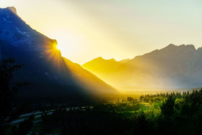 Scenic view of silhouette mountains against sky at sunset