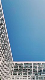 Low angle view of modern building against clear blue sky