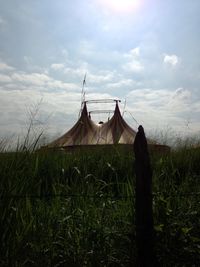 Built structure on field against sky