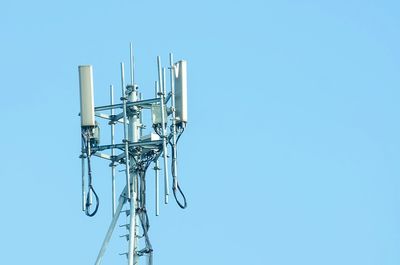 Low angle view of television tower against clear blue sky