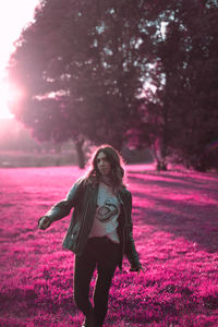 Portrait of young woman standing on tree