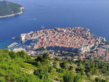 High angle view of buildings and sea in city