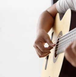 Midsection of man playing guitar