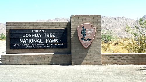 Information sign on wall against clear sky