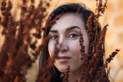 Portrait of young woman by plants