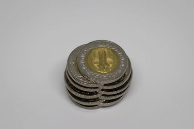 High angle view of coins on white background