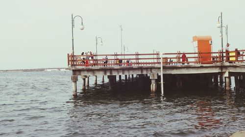 Pier on sea against clear sky