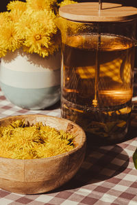 Preparing dandelion flower healthy tea in glass cup on table. herbal medicine delicious tisane tea