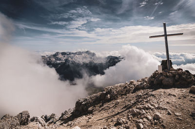 Panoramic view of cross on mountain against sky