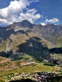 Scenic view of mountains against cloudy sky