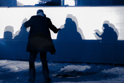 Person standing on snow covered landscape