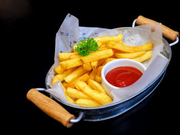 Close-up of food served on table against black background