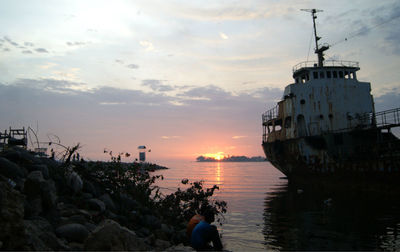 Boat moored on sea against sky