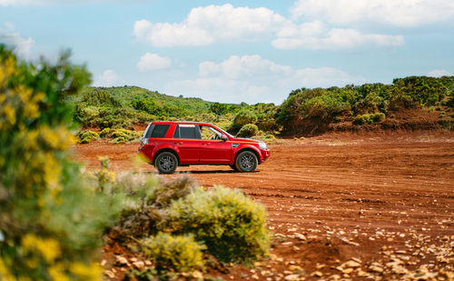 Car in red desert in greece