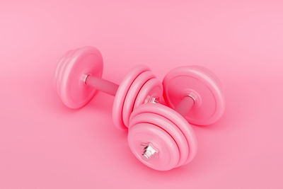 Close-up of dumbbells on red background