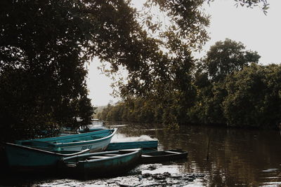 Boats moored in lake against sky