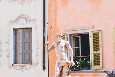 Low angle view of statue against building