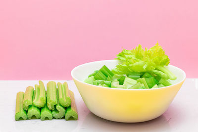 Close-up of food in bowl against pink background