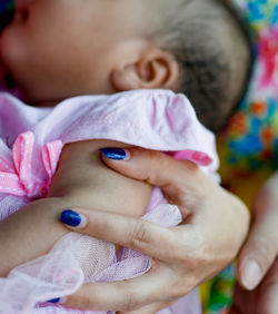 Close-up of baby girl with mother