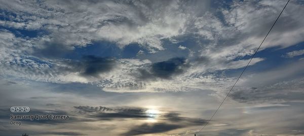 Low angle view of text on cable against sky
