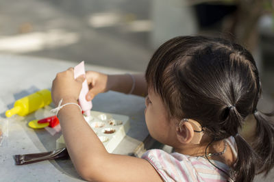 Close-up of cute girl with clay