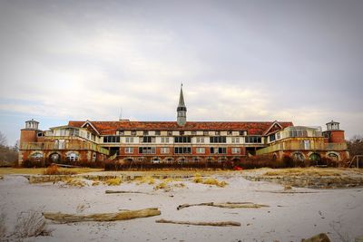 Buildings against cloudy sky