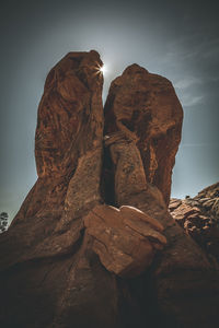 Low angle view of rock formation against sky