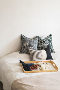 Linen pillows on a white bed with home decor. still life details in home on a bed. cozy home.