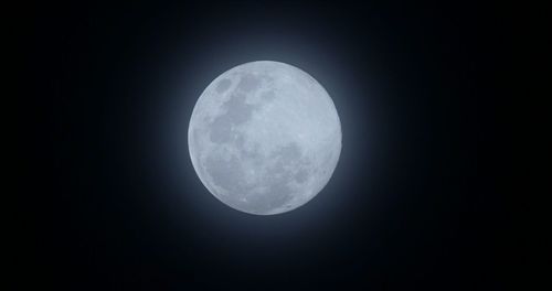 Low angle view of moon against clear sky at night