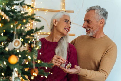 Man and woman holding christmas tree