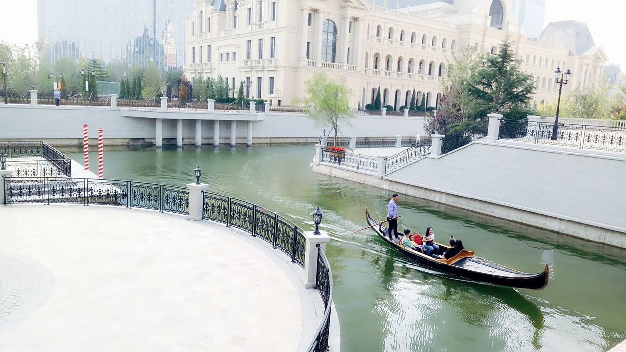 PANORAMIC VIEW OF PEOPLE ON CITY BY RIVER