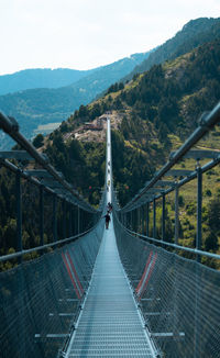 View of bridge over mountains against sky