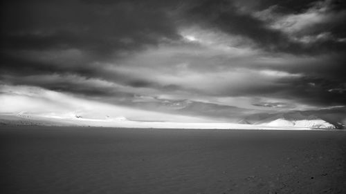 Scenic view of landscape against cloudy sky