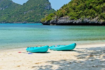 Boat moored on shore at beach