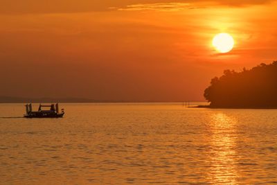 Scenic view of sea against orange sky