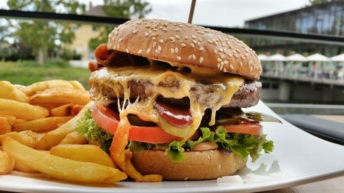 Close-up of burger with french fires served in restaurant