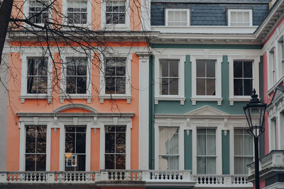 Orange, turquoise and pink pastel coloured terraced houses in primrose hill, london, uk.