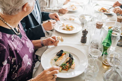 High angle view of senior woman with food in restaurant