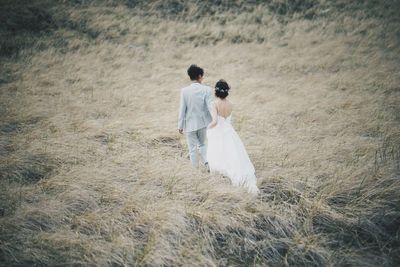 Rear view of woman standing on field