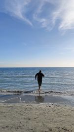 Man on beach against sky