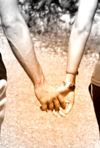 Cropped image of couple holding hands