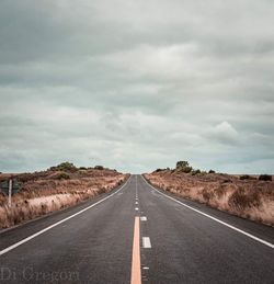 Empty road along countryside landscape