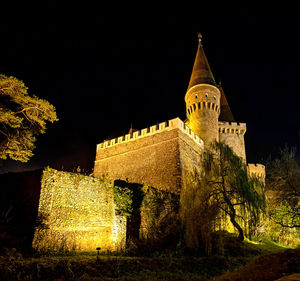 Low angle view of illuminated building against sky at night