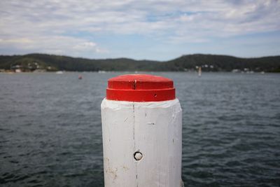 Close-up of red boat in sea against sky