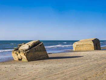 Large rocks on beach on sunny day