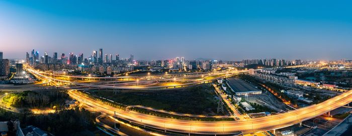 High angle view of illuminated cityscape against sky at night