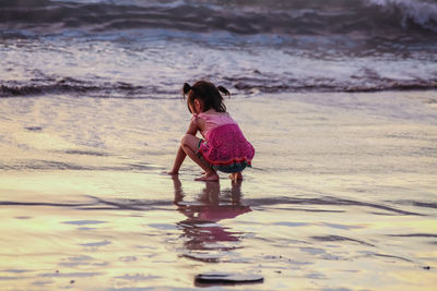 Full length of girl standing on beach