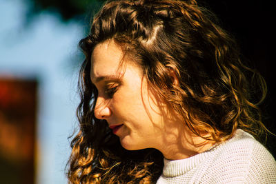 Close-up portrait of young woman looking away