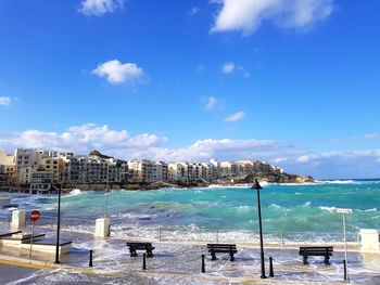 View of swimming pool at beach against blue sky